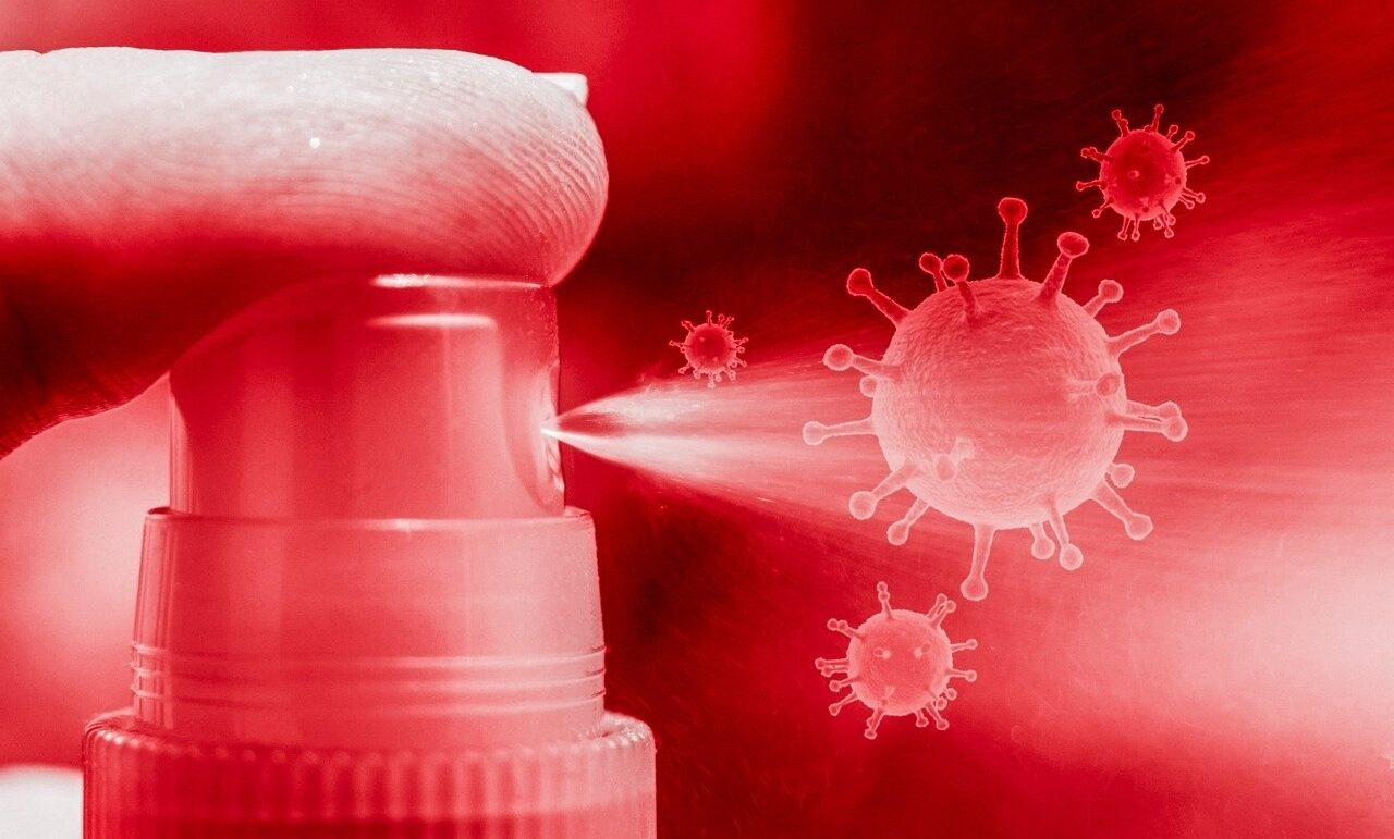 Röd bild av en spraystråle som sprayar på en symbol som föreställer ett virus